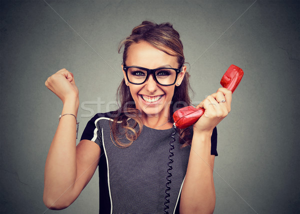 Young woman in glasses receiving great news by phone Stock photo © ichiosea