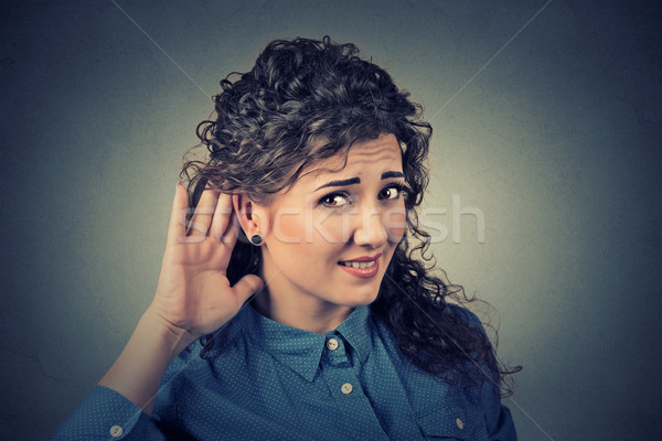 unhappy hard of hearing woman placing hand on ear asking someone to speak up Stock photo © ichiosea