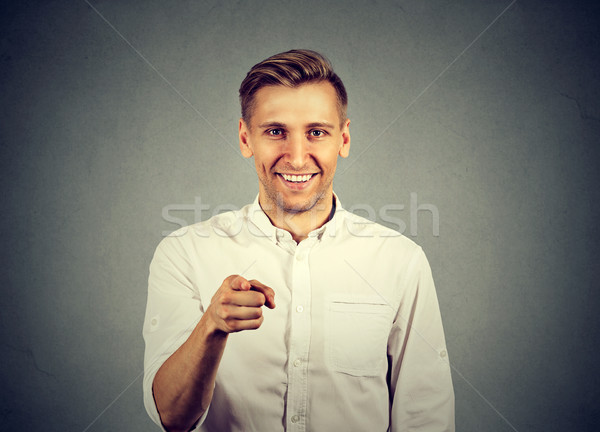 Portrait of a young man pointing his finger at you Stock photo © ichiosea