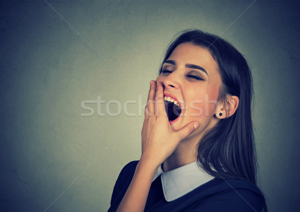 Sleepy woman with wide open mouth yawning looking bored  Stock photo © ichiosea
