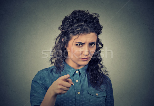 angry young woman pointing at camera isolated on gray background Stock photo © ichiosea