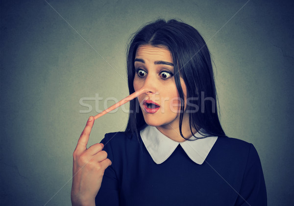 Stock photo: Woman with long nose. Liar concept. 
