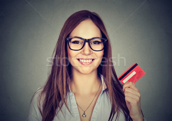 Happy woman in glasses showing credit card Stock photo © ichiosea