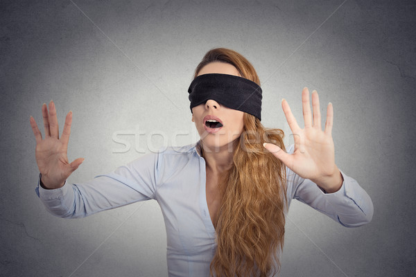 Young businesswoman walking blindfolded with hands forward Stock photo © ichiosea