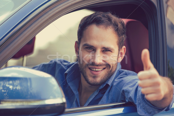 Man driver happy smiling showing thumbs up driving sports car Stock photo © ichiosea