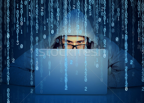 Człowiek hacker pracy laptop kod binarny młody człowiek Zdjęcia stock © ichiosea