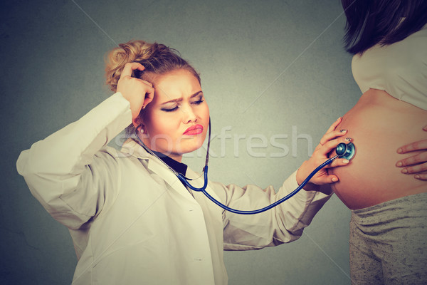 Doctor listening to pregnant patient Stock photo © ichiosea