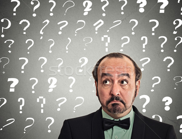 man with puzzled face expression has many questions Stock photo © ichiosea