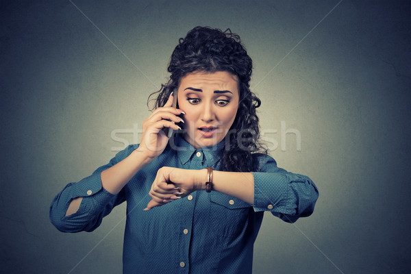 time management concept. Stressed businesswoman looking at wrist watch, running late Stock photo © ichiosea