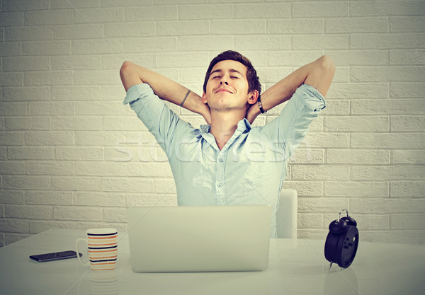 Nyugodt férfi laptop ül asztal téglafal Stock fotó © ichiosea