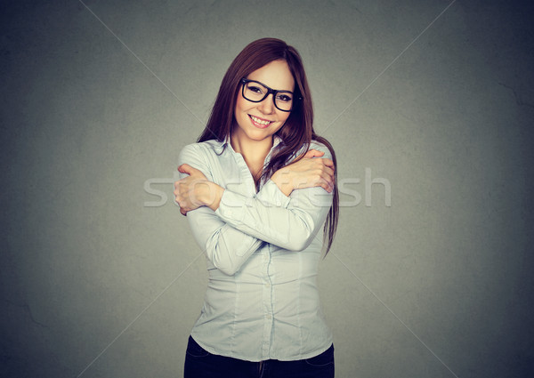 Smiling woman holding hugging herself  Stock photo © ichiosea
