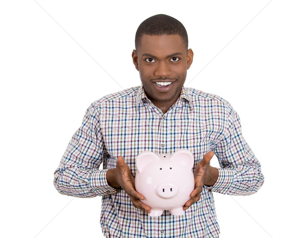 young man with piggy bank happy about his savings Stock photo © ichiosea