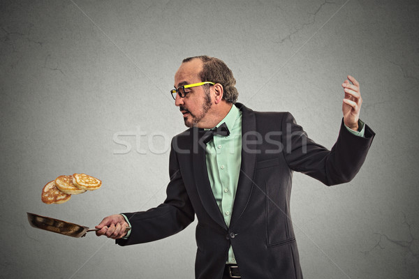 smiling man tossing pancakes on frying pan Stock photo © ichiosea