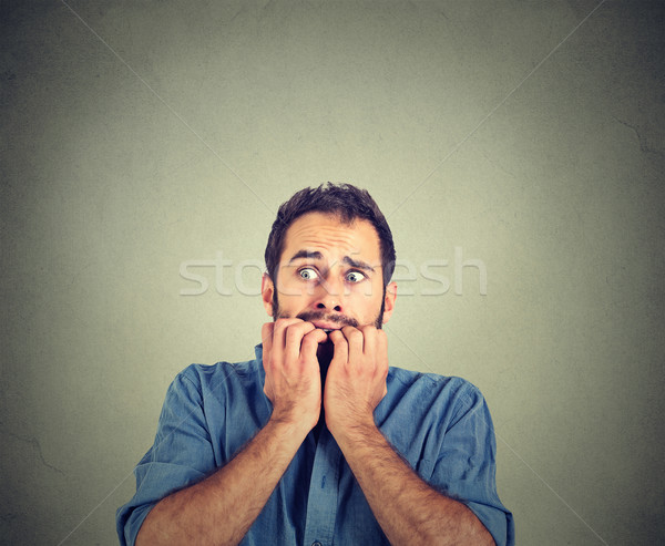 Portrait anxious young man biting his nails fingers freaking out  Stock photo © ichiosea