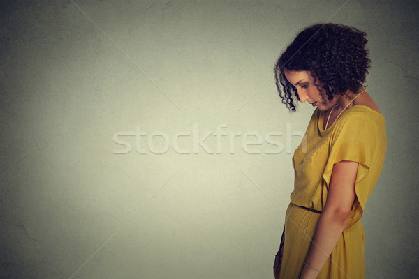 Side profile sad lonely young woman looking down Stock photo © ichiosea