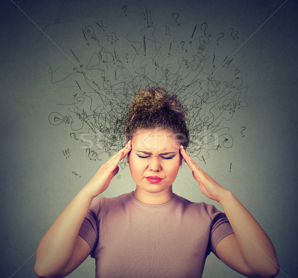 woman with worried stressed face expression and brain melting into lines question marks.  Stock photo © ichiosea