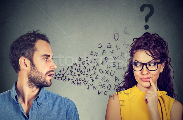 Language barrier concept. Man talking to a young woman with question mark  Stock photo © ichiosea