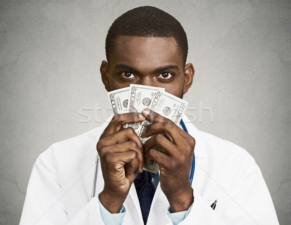 Greedy health care professional, doctor holding cash, money Stock photo © ichiosea