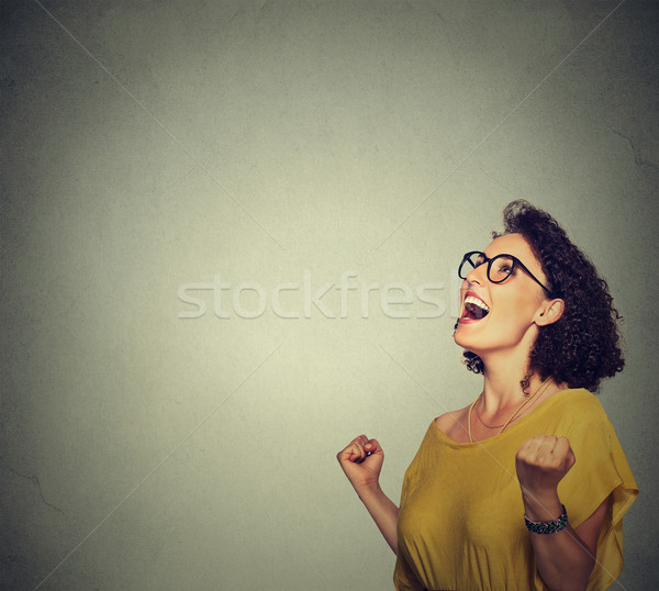 happy woman in yellow dress exults pumping fists ecstatic celebrates success Stock photo © ichiosea