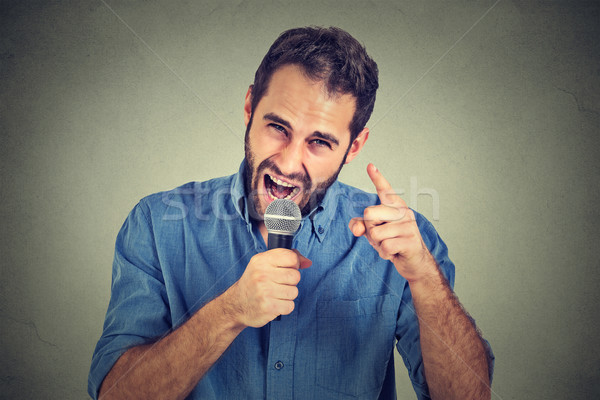 Angry man screaming in microphone Stock photo © ichiosea