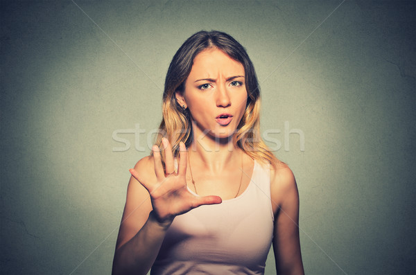 Stock photo: angry annoyed woman raising hand up to say no stop 