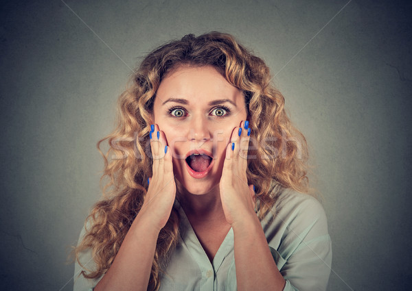 Stock photo: Surprised young woman shouting looking at camera