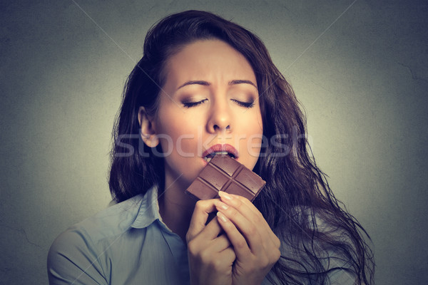 Beautiful woman eating chocolate Stock photo © ichiosea