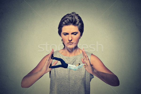 Conceptual creative shot of a man being clamped squeezed in female hands trying to resist pressure  Stock photo © ichiosea