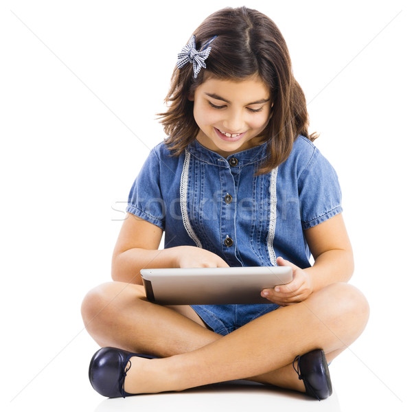 Stock photo: Young girl using a tablet