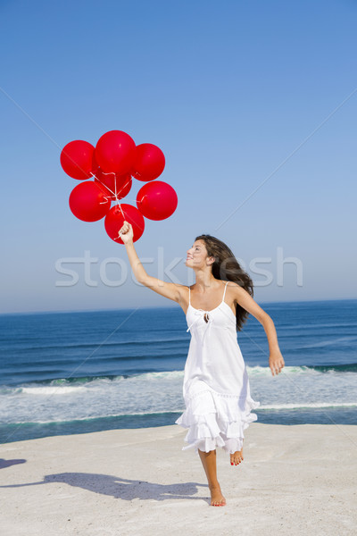 Beautiful girl running with red ballons Stock photo © iko