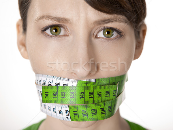 Kalóriák portré fiatal nő zöld mérőszalag befogja száját Stock fotó © iko