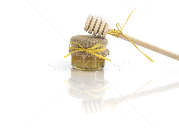 Stock photo: Wooden honey drizzlier and a jar of honey