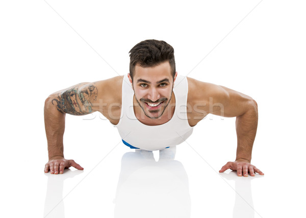 Athletic man making pushups Stock photo © iko