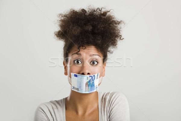 Stock photo: Covering mouth with a euro banknote