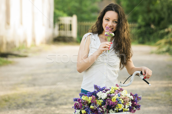 Stock photo: Happy girl with her bicycle