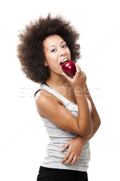 African American  young woman holding and eating an apple Stock photo © iko