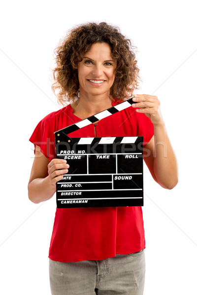 Happy mature woman holding a clapboard Stock photo © iko