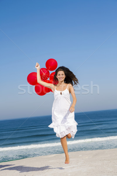 Beautiful girl running with red ballons Stock photo © iko