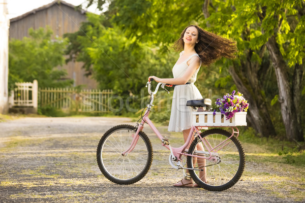 Happy girl with her bicycle Stock photo © iko