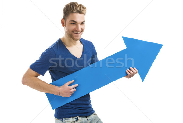 Young man holding a blue arrow Stock photo © iko