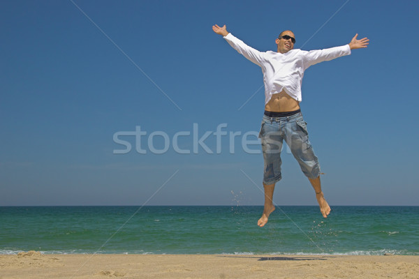 Człowiek skoki plaży niebo sportu fitness Zdjęcia stock © iko