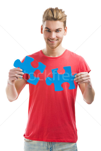 Young man holding a puzzle piece Stock photo © iko