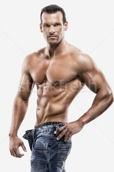 Muscle man posing in studio, isolated over a white background Stock photo © iko