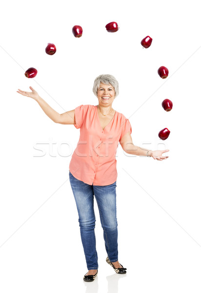 Old woman throwing apples Stock photo © iko
