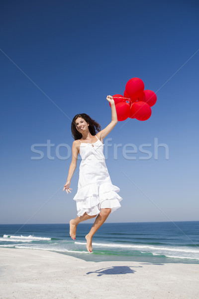 Jumping rosso bella ragazza donna spiaggia ragazza Foto d'archivio © iko