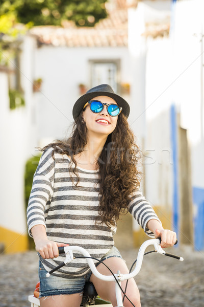 Happy girl riding a bicycle  Stock photo © iko