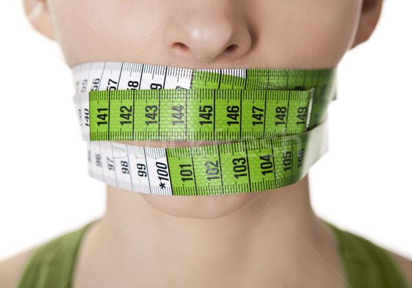 Kalóriák portré fiatal nő zöld mérőszalag befogja száját Stock fotó © iko