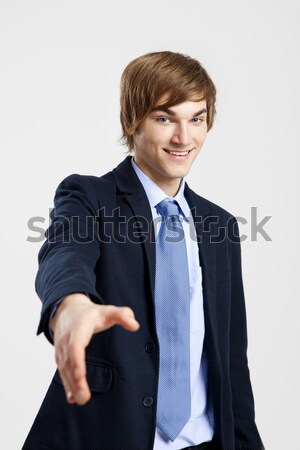 Foto stock: Empresario · apretón · de · manos · jóvenes · estrechar · la · mano · gris · sonrisa