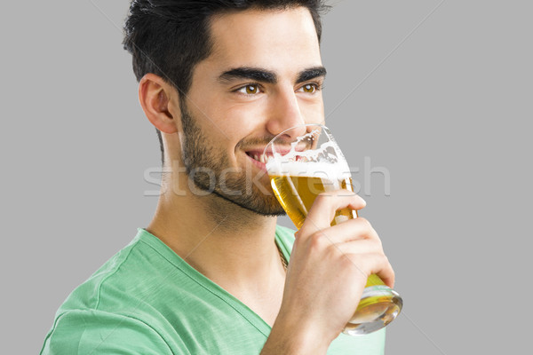 Jeune homme potable bière portrait élégant dégustation [[stock_photo]] © iko