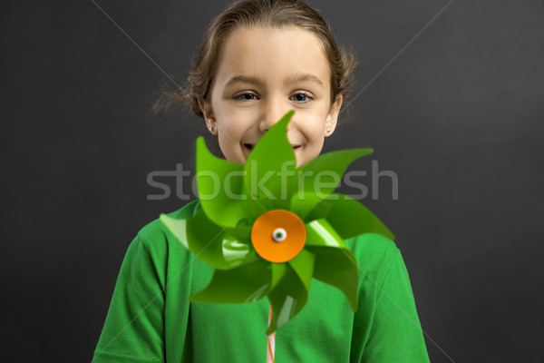 Stock photo: Little girl holding a windmill